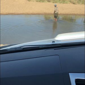 Sam testing the water depth before we head across